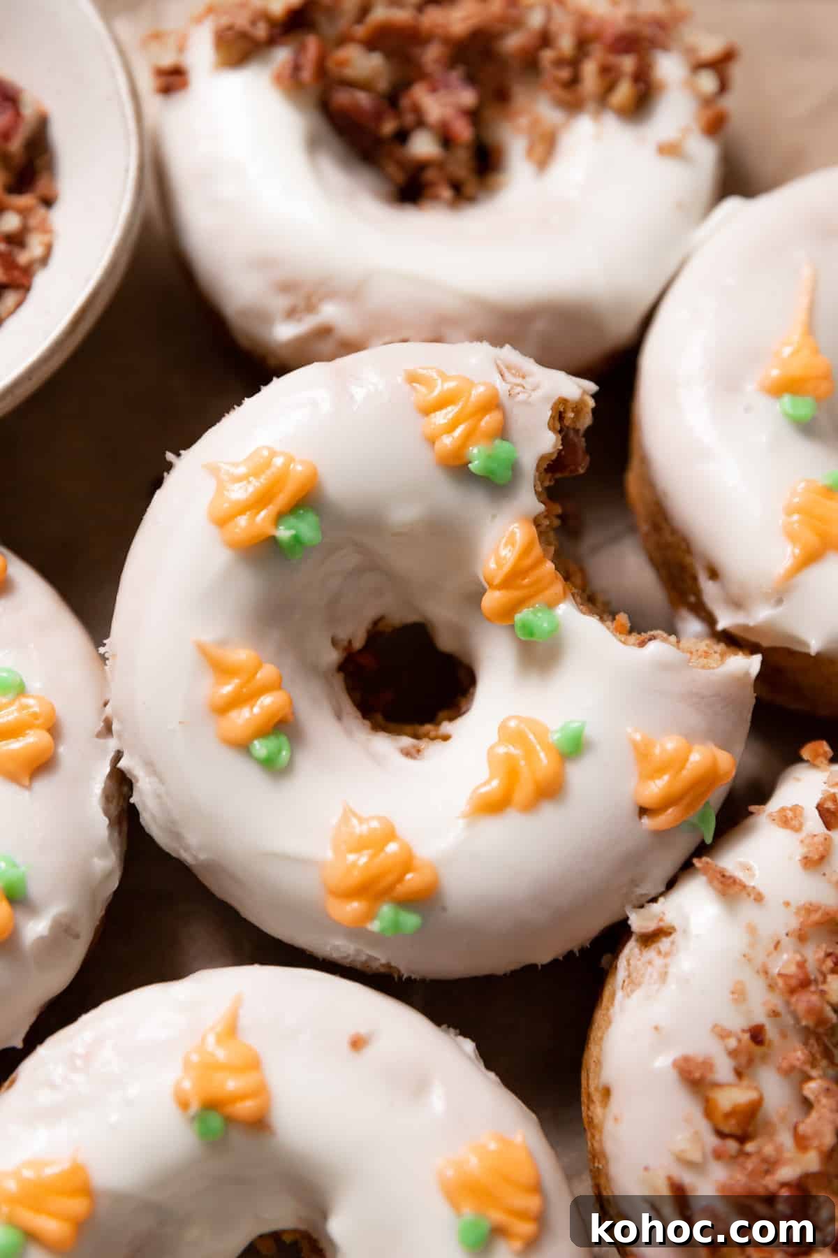 Carrot Cake Donuts Recipe: Moist Spiced Donuts with Cream Cheese Glaze 2 carrot cake donuts with cream cheese icing.