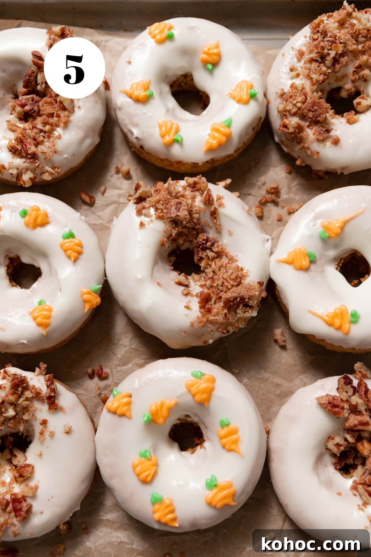 Carrot Cake Donuts Recipe: Moist Spiced Donuts with Cream Cheese Glaze 5 carrot cake donuts with cream cheese icing and candied pecans.