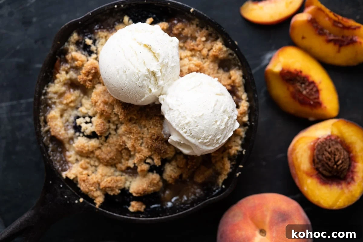 Keto Almond Flour Peach and Blackberry Crisp Recipe 4 Freshly baked peach and blackberry crisp with two scoops of vanilla ice cream