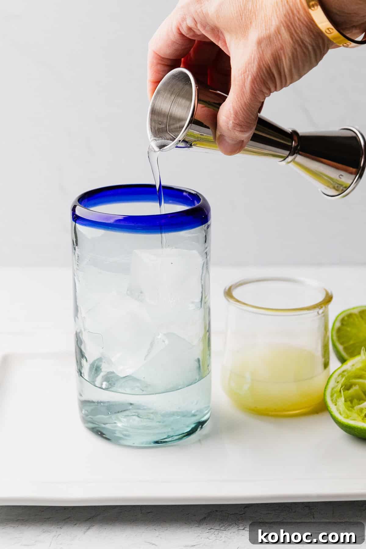 How to Make a Classic Texas Ranch Water Cocktail 5 Pouring tequila into glass.