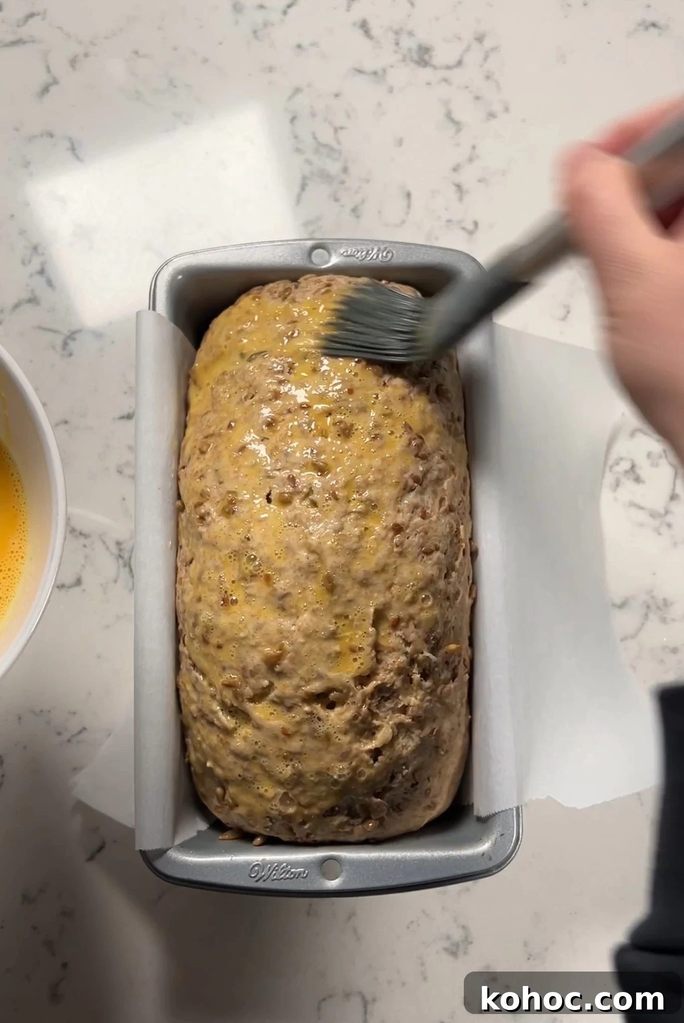 Whole Grain Loaf Recipe: Rustic Nordic Grovbrød Guide 16 Egg washing the bread.