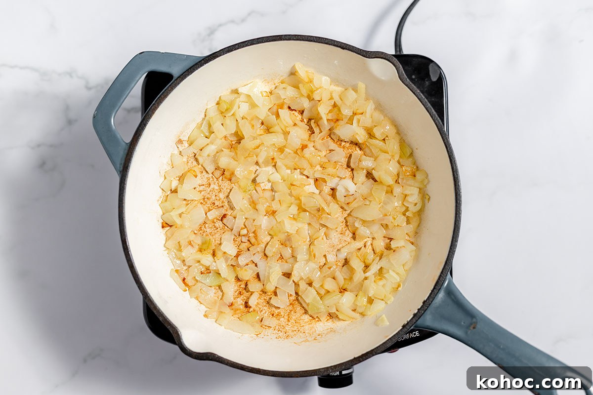 Creamy Baked Potato Soup with Crispy Bacon Topping 5 Onions sauteed in butter in a skillet.