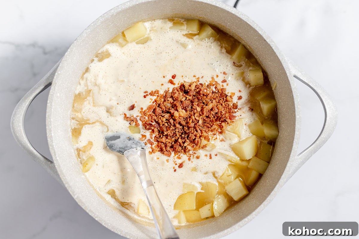 Creamy Baked Potato Soup with Crispy Bacon Topping 7 Creamy onion mixture added to potatoes in the stock pot.