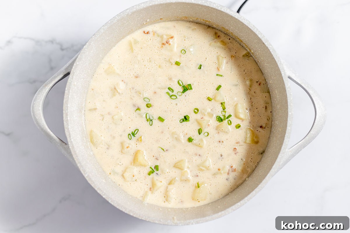 Creamy Baked Potato Soup with Crispy Bacon Topping 8 Baked Potato Soup simmering in the stock pot.