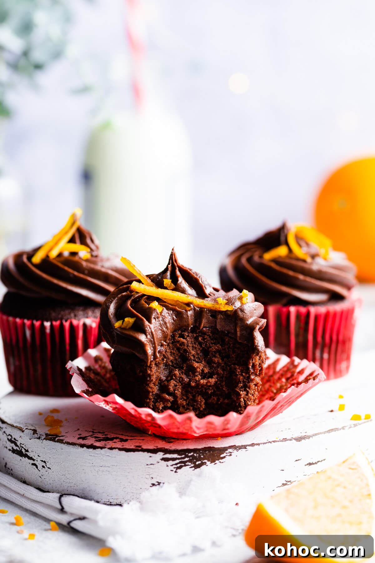 Chocolate Orange Cupcakes Recipe with Zesty Ganache 11 side angle view at an orange cupcake with a bite taken out
