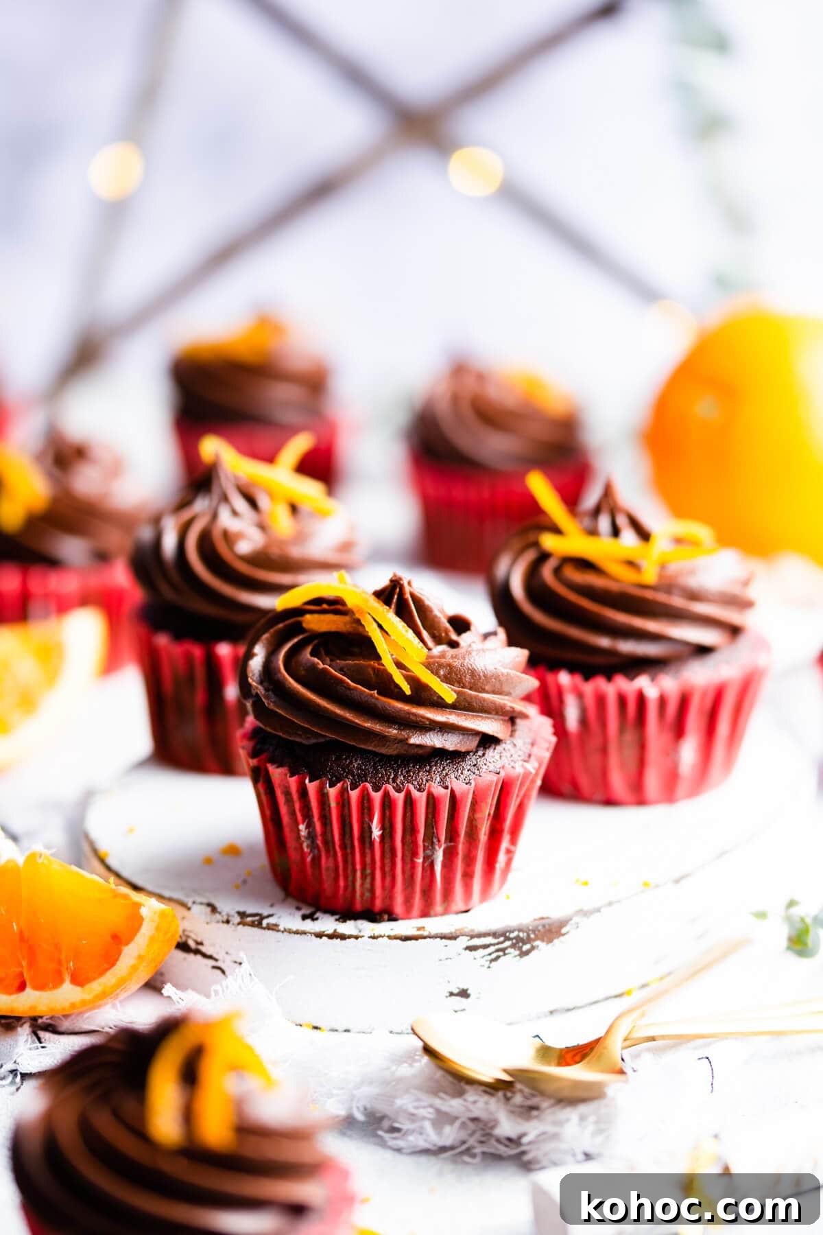 Chocolate Orange Cupcakes Recipe with Zesty Ganache 12 straight ahead side view of chocolate orange cupcake on small white board