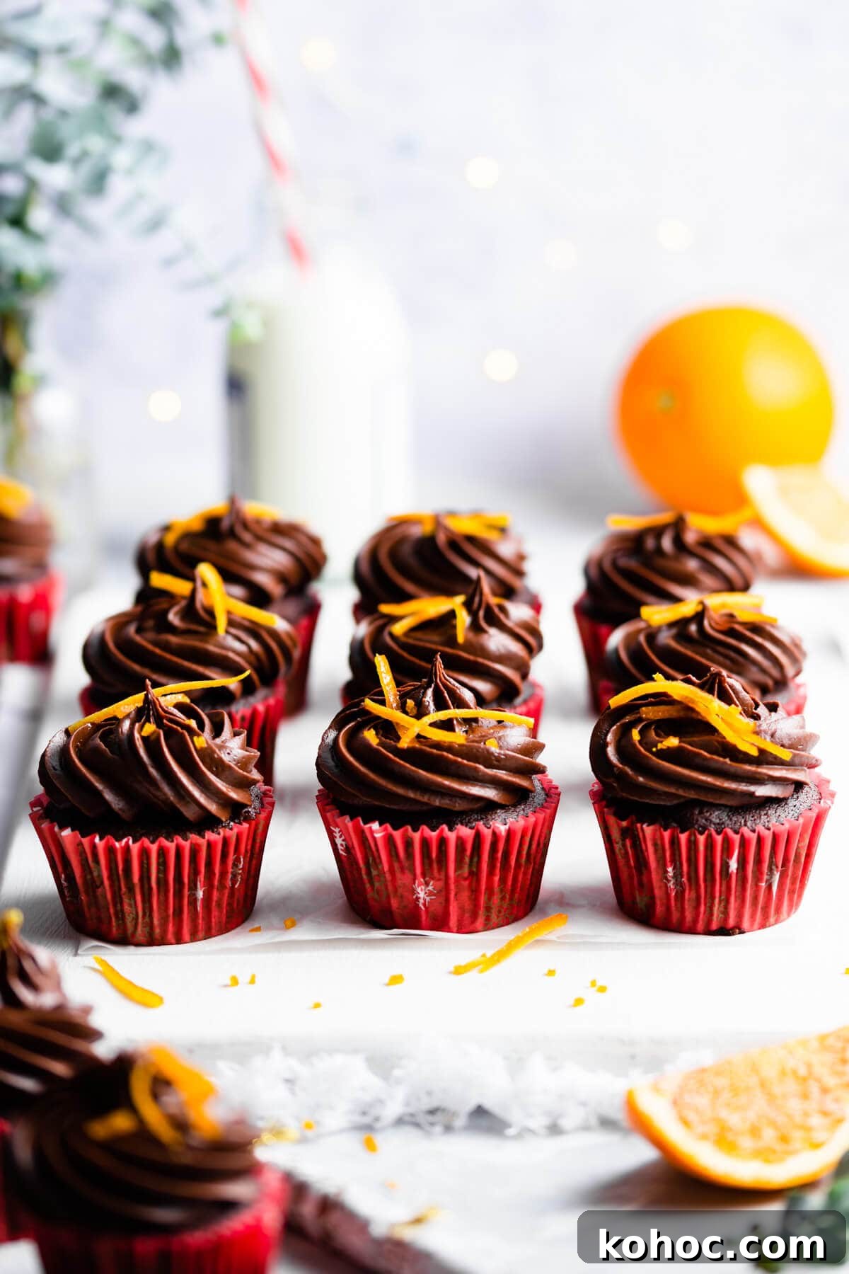 Chocolate Orange Cupcakes Recipe with Zesty Ganache 8 45 degree angle view at chocolate orange cupcakes topped with orange peel