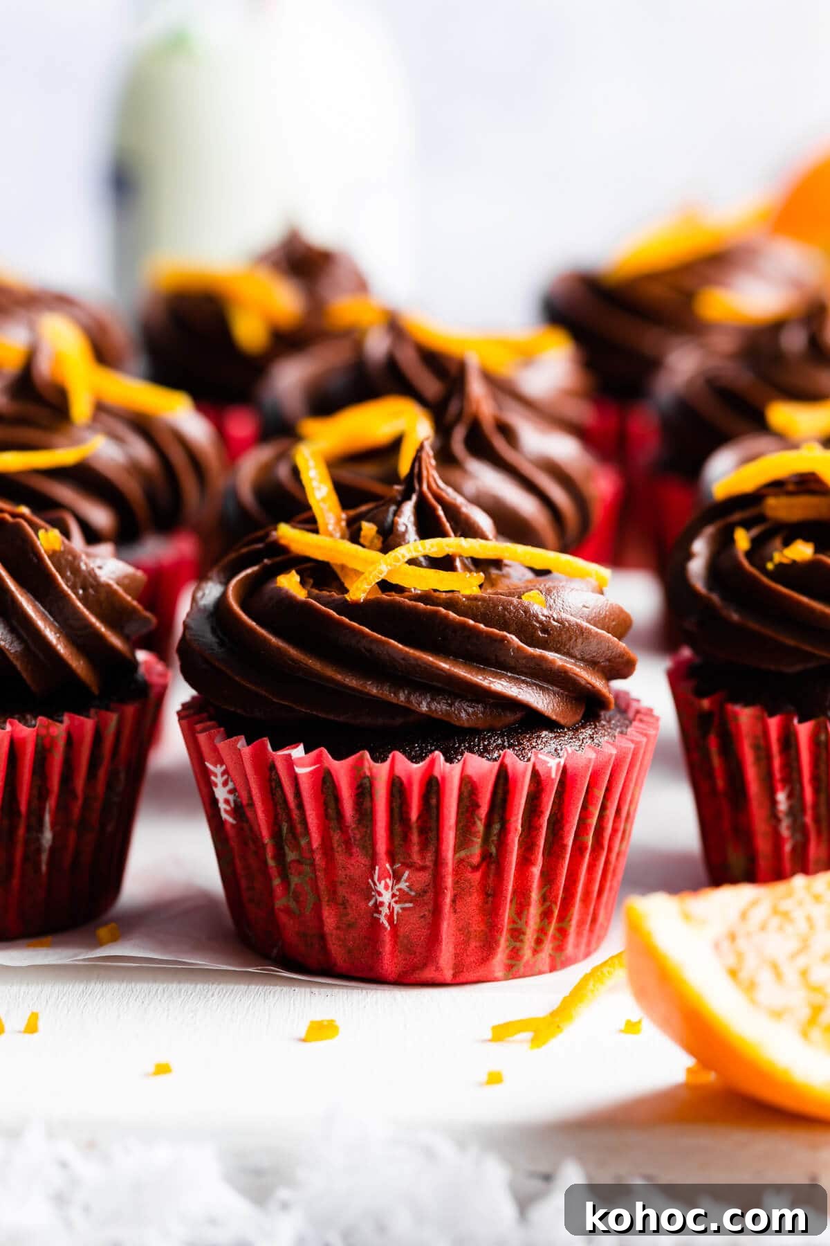 Chocolate Orange Cupcakes Recipe with Zesty Ganache 9 side supaer close up at a single chocolate cupcake with orange peel