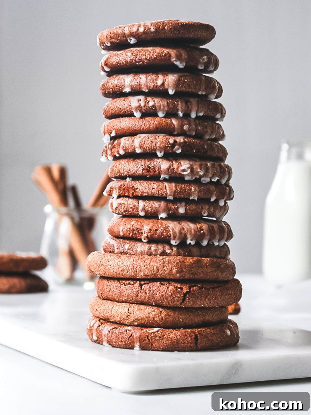 Chewy Pumpkin Snap Cookies Recipe — Soft Spiced Fall Treat 2 pumpkin cookies on a white board served with milk.