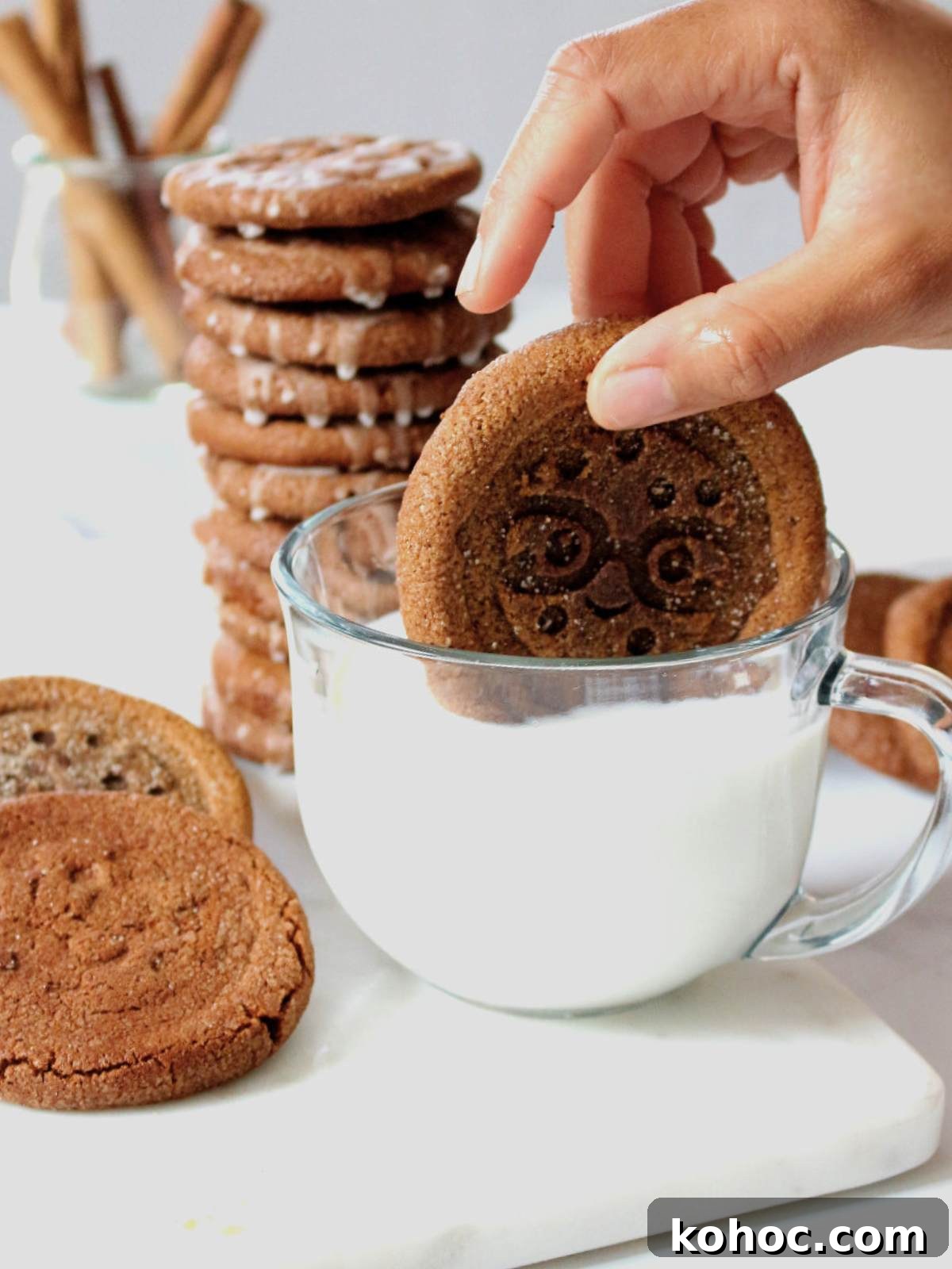 Chewy Pumpkin Snap Cookies Recipe — Soft Spiced Fall Treat 8 dunking cookies into a cup with milk.