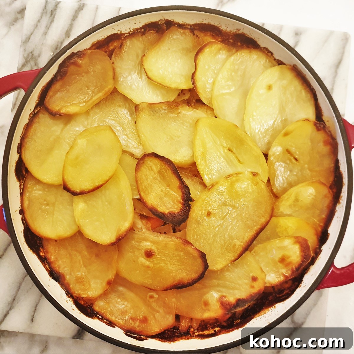 Savory Pork and Cabbage Hotpot Recipe for Cozy Weeknights 3 Pork and cabbage hotpot covered with a layer of crispy potatoes.