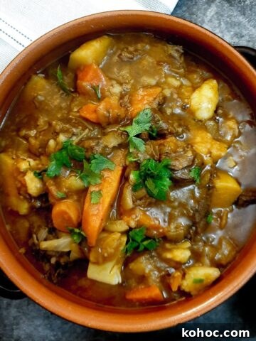 A dish of easy beef stew garnished with chopped parsley.