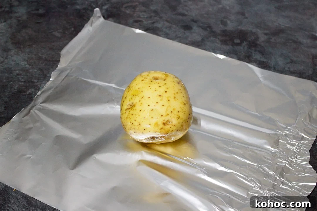 Slow Cooker Baked Jacket Potatoes Recipe 13 a baking potato rubbed with olive oil and salt on a sheet of foil