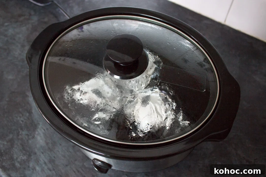 Slow Cooker Baked Jacket Potatoes Recipe 16 jacket potatoes wrapped in foil, cooking in a slow cooker