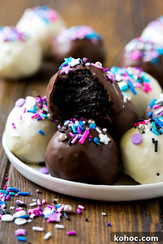Oreo Balls plated A plate of dark and white chocolate Oreo balls topped with colorful sprinkles.