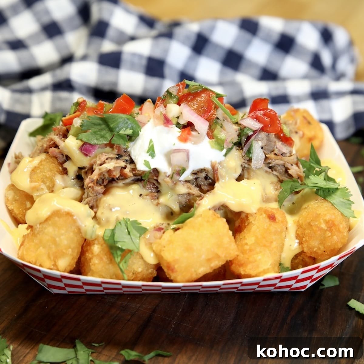 Slow-Cooker Pulled Pork Casserole with Cheesy Topping 11 Boat of tater tot nachos topped with pulled pork.