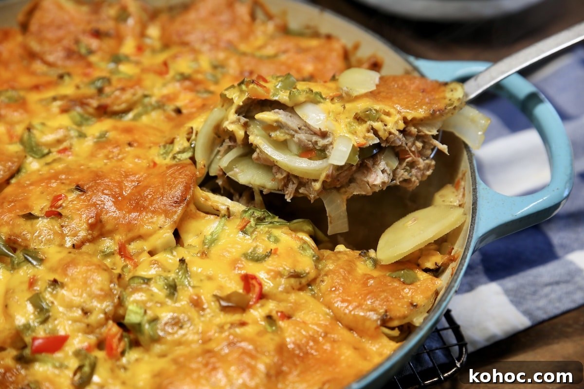 Slow-Cooker Pulled Pork Casserole with Cheesy Topping 6 Spoonful of pork casserole with potatoes and cheese.