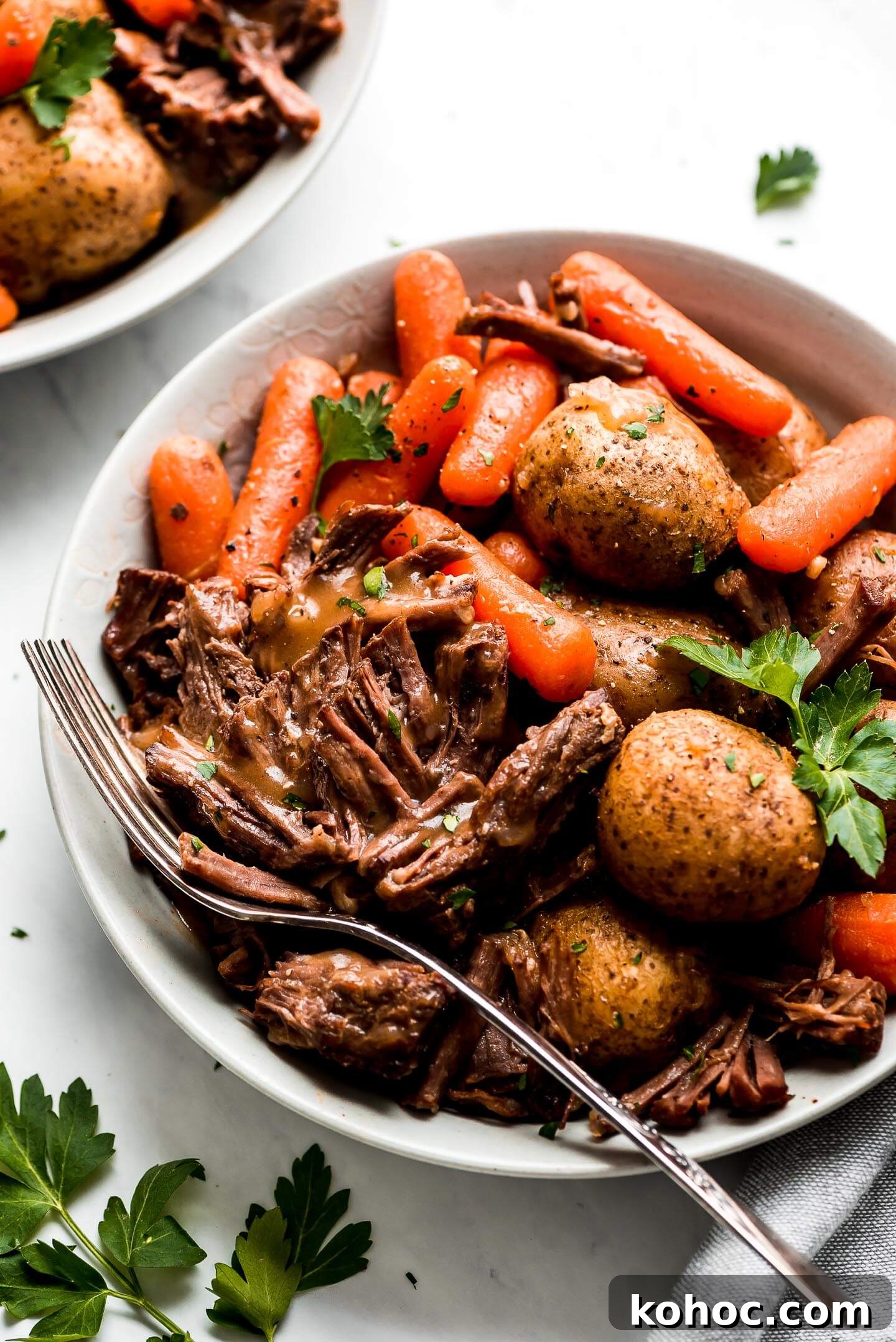 Juicy Instant Pot Pot Roast Recipe for Tender, Quick Dinner 8 Instant Pot Pot Roast in a bowl with carrots, and baby yukon potatoes.
