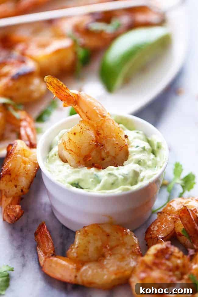 Grilled Spicy Lime Shrimp with Creamy Avocado Cilantro Sauce on a table.