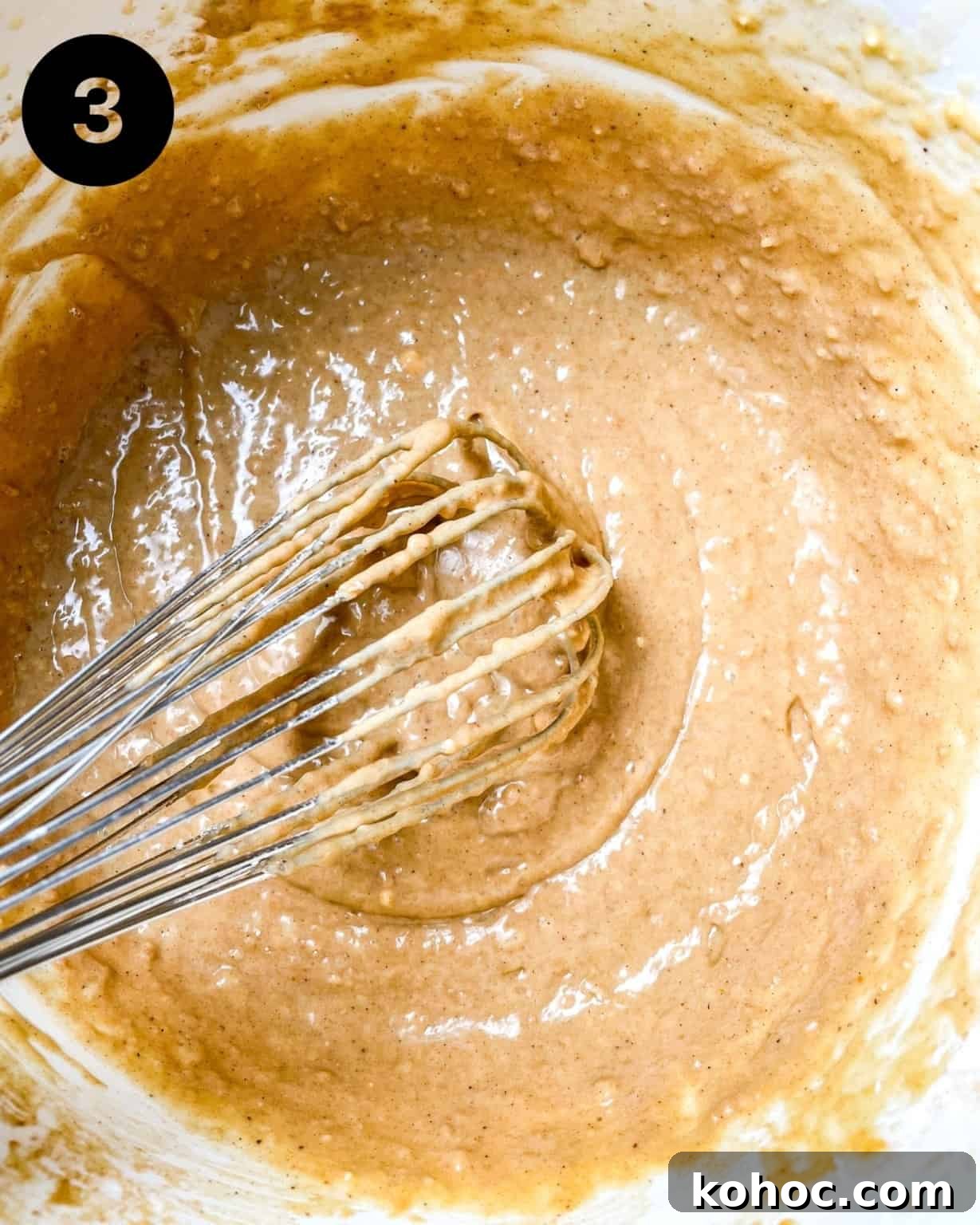 Gingerbread Muffins with Molasses Glaze: Cozy Holiday Treats 8 muffin batter in a bowl with a whisk.