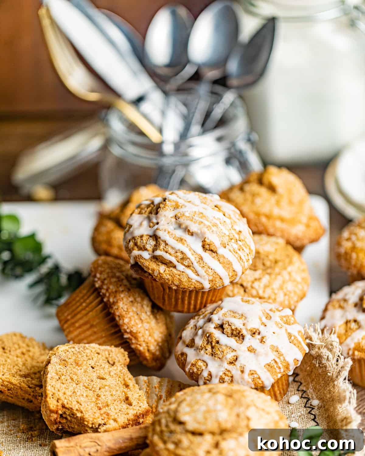 Gingerbread Muffins with Molasses Glaze: Cozy Holiday Treats 9 muffins piled on top of each other on a serving board.