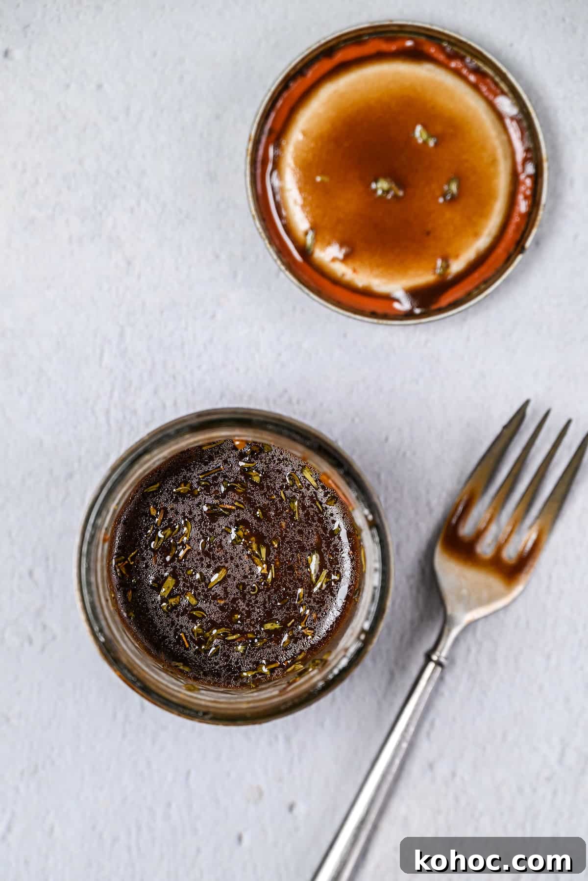 A mason jar opened with a balsamic dressing inside.