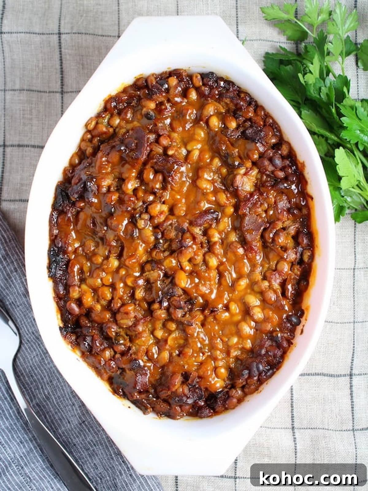 22 Memorial Day Recipes for the Ultimate Backyard BBQ 15 Baking dish filled with baked beans sitting on a counter.