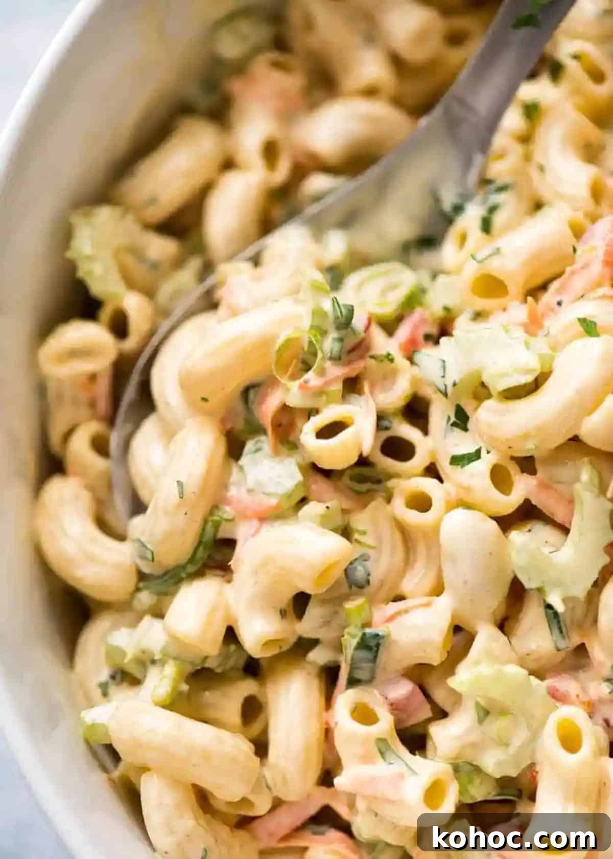 22 Memorial Day Recipes for the Ultimate Backyard BBQ 18 Close up of pasta salad in a bowl covered in dressing.