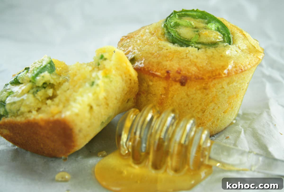 22 Memorial Day Recipes for the Ultimate Backyard BBQ 19 Honey jalapeno cornbread muffins with honey on table.