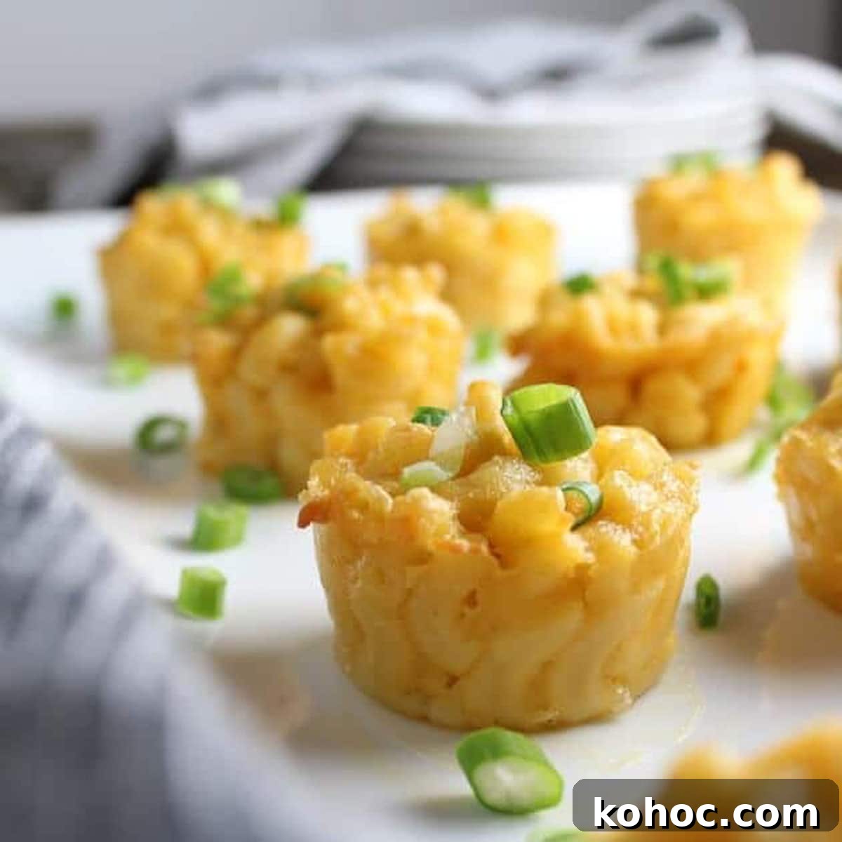 22 Memorial Day Recipes for the Ultimate Backyard BBQ 6 Mini macaroni and cheese cups on a table topped with chives.