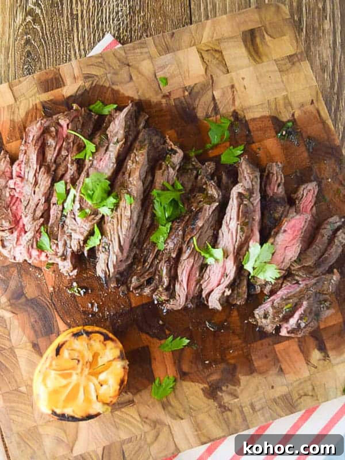 22 Memorial Day Recipes for the Ultimate Backyard BBQ 7 Slices skirt steak on a cutting board topped with cilantro.