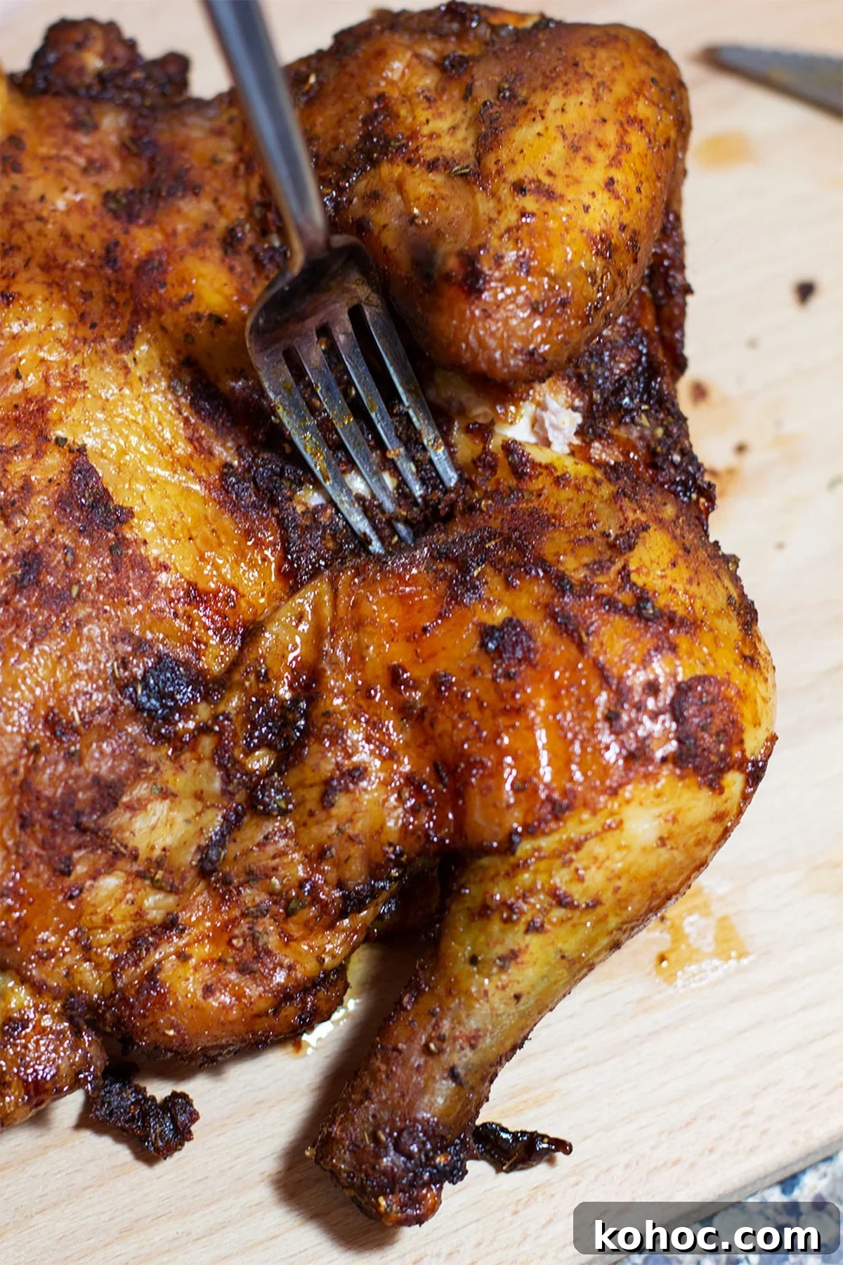 22 Memorial Day Recipes for the Ultimate Backyard BBQ 10 Applewood Smoked Chicken on a wooden cutting board, fork in chicken.