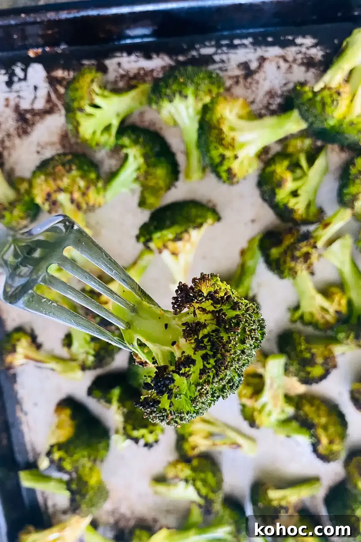 Crispy Garlic Broiled Broccoli Recipe — Quick Crispy Broccoli 11 broiled broccoli on a fork.