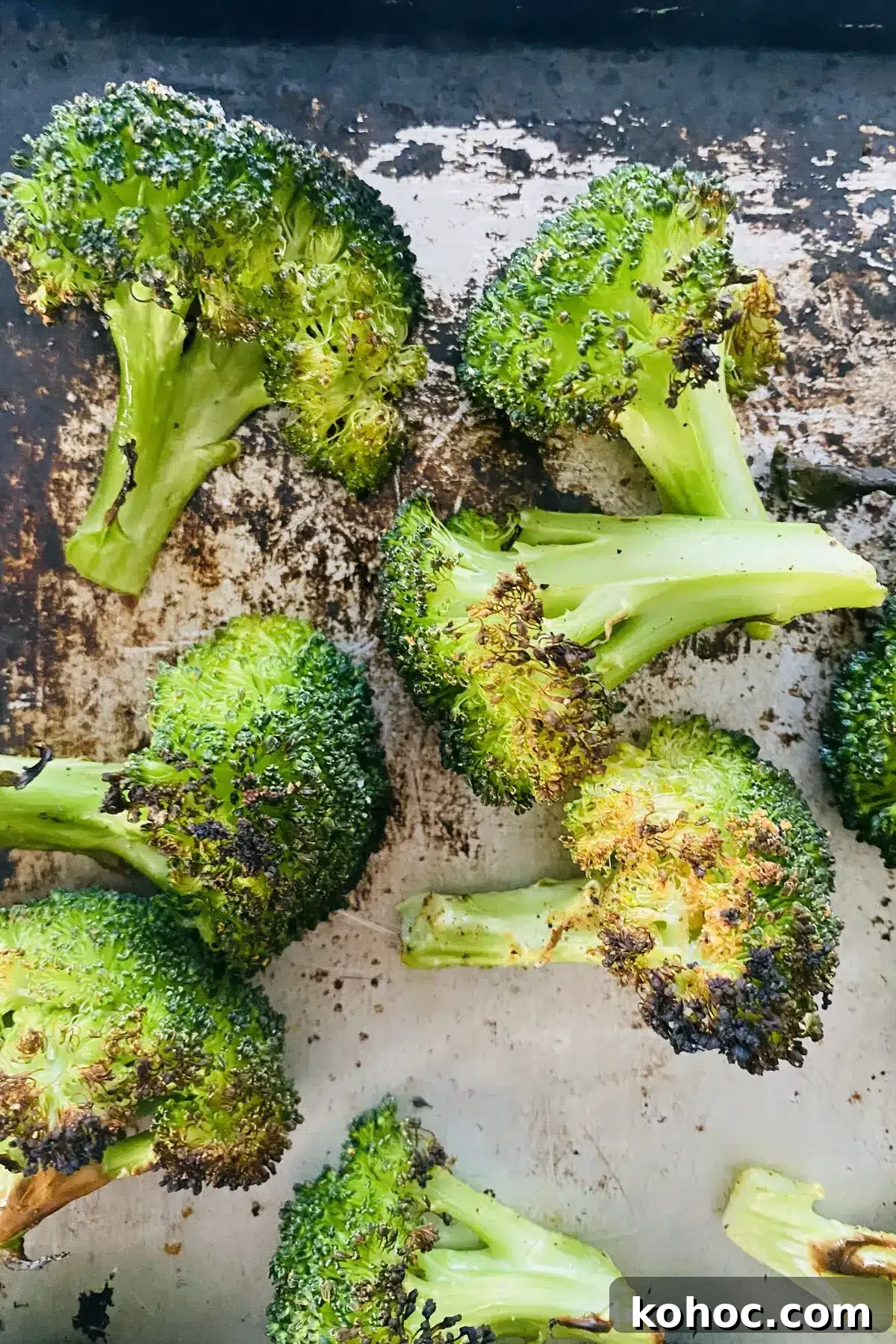 Crispy Garlic Broiled Broccoli Recipe — Quick Crispy Broccoli 12 closeup of broiled broccoli on a baking sheet.