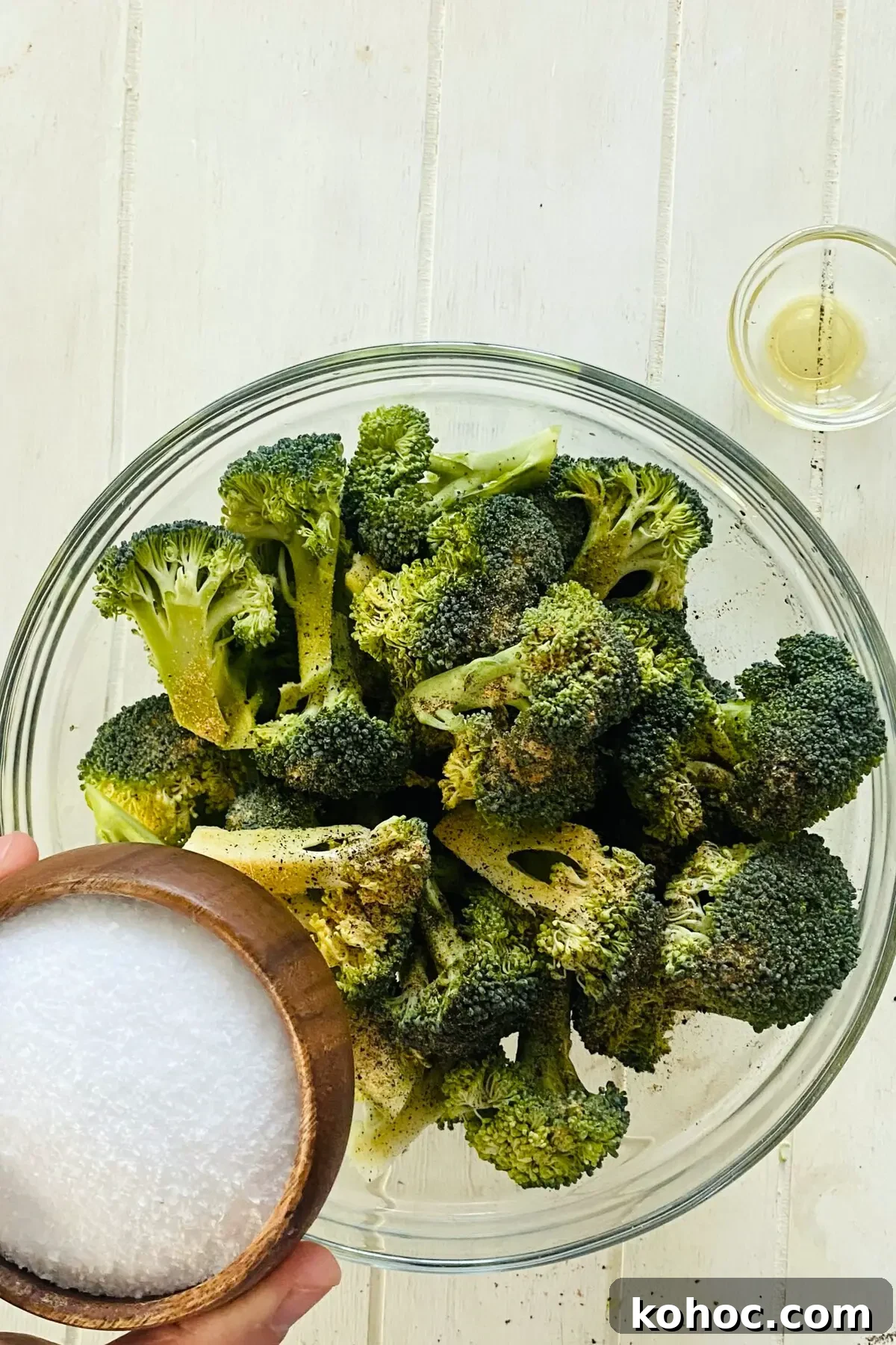 Crispy Garlic Broiled Broccoli Recipe — Quick Crispy Broccoli 8 adding kosher salt to raw broccoli.