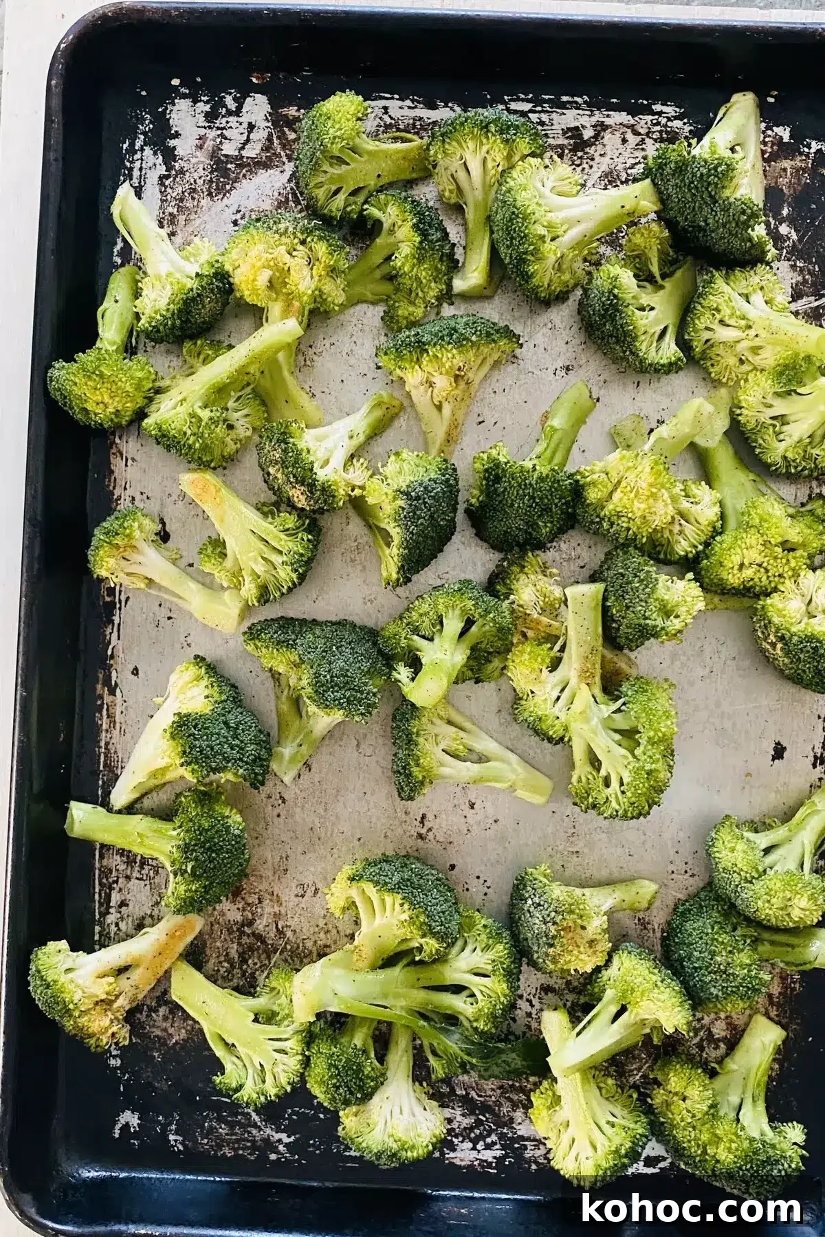 Crispy Garlic Broiled Broccoli Recipe — Quick Crispy Broccoli 9 raw broccoli seasoned and on a baking sheet.