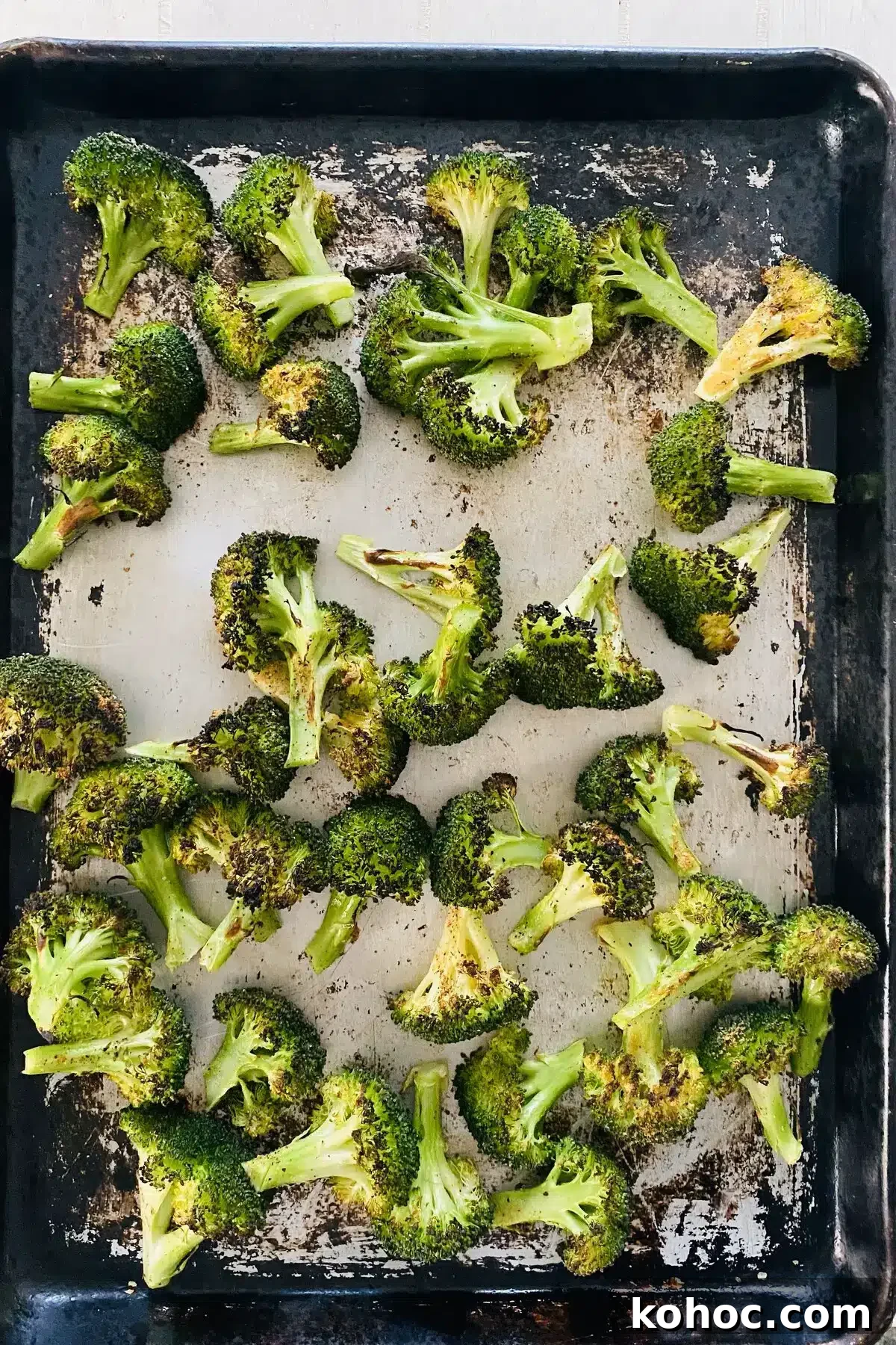 Crispy Garlic Broiled Broccoli Recipe — Quick Crispy Broccoli 10 broiled broccoli recipe with broccoli on a sheet pan.