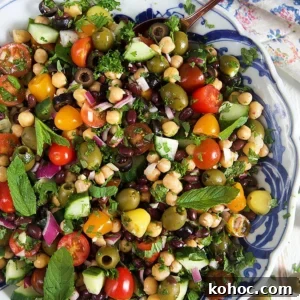 Mediterranean Chickpea Salad with Lemon, Herbs & Feta 10 overhead shot of mediterranean chickpea salad in a blue and white bowl.
