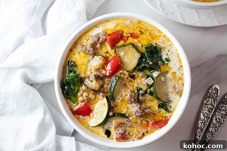 overhead view of ready to serve keto zuppa toscana soup in a white bowl
