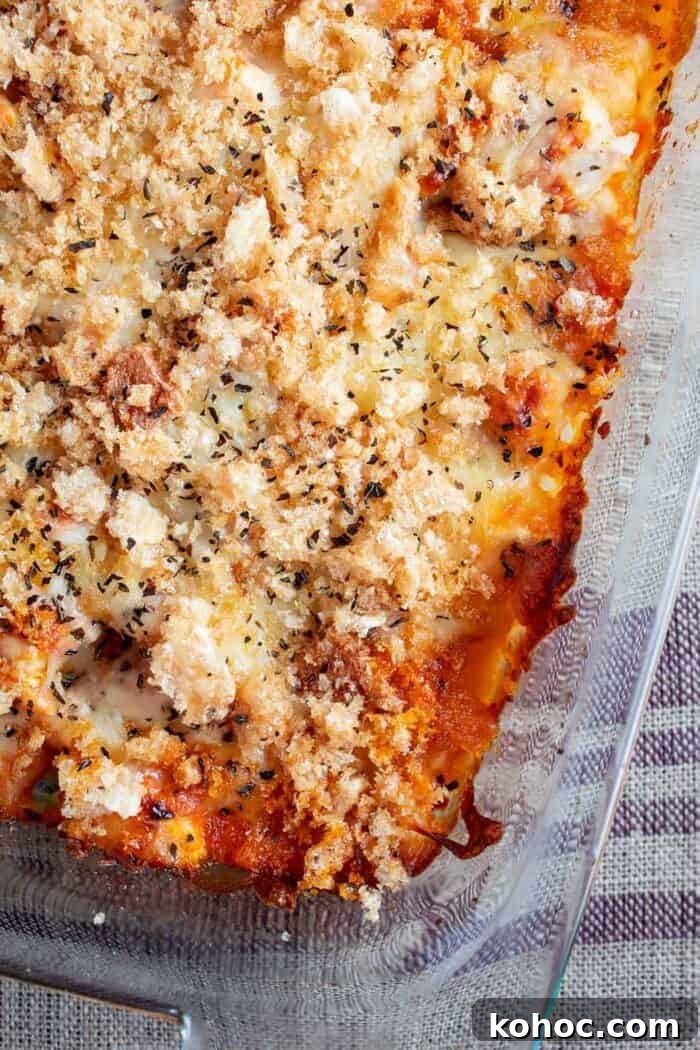 overhead view of keto chicken parmesan casserole in glass casserole dish ready to serv