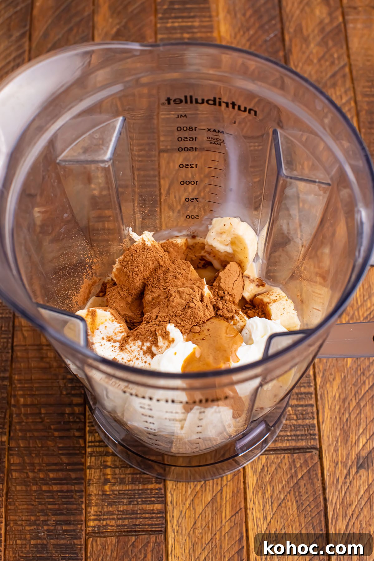 Creamy Chocolate Peanut Butter Banana Smoothie 4 Frozen banana, peanut butter, yogurt, milk, cocoa powder, and honey in a blender.