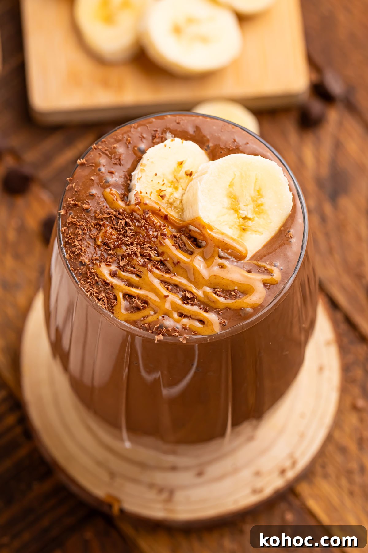 Creamy Chocolate Peanut Butter Banana Smoothie 6 Chocolate Peanut Butter Banana Smoothie in a glass, topped with sliced bananas.