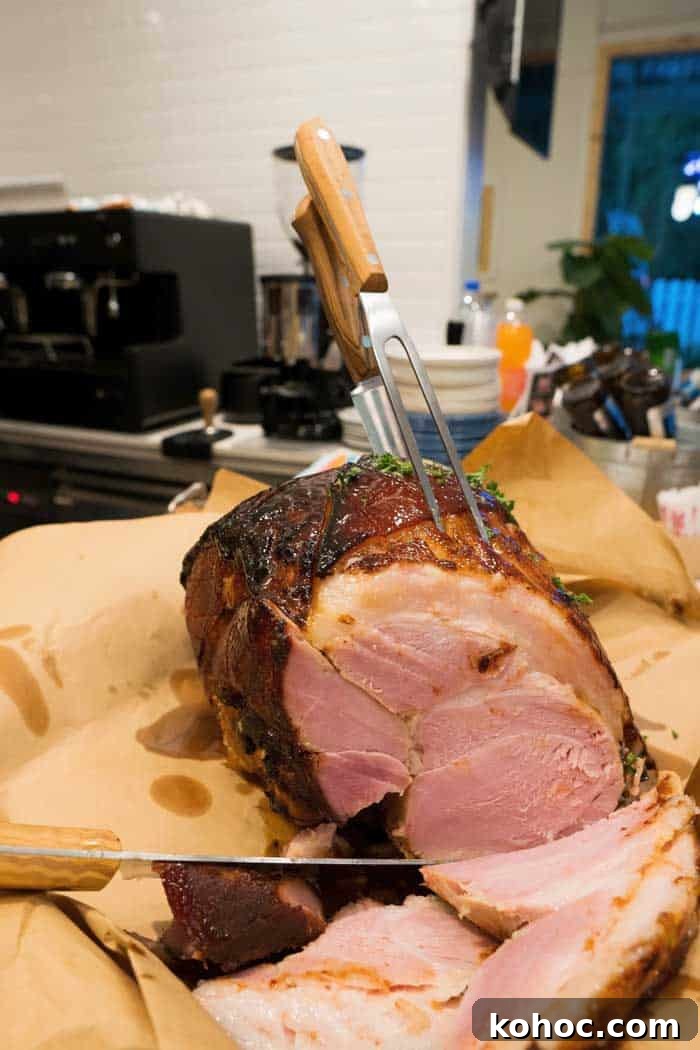 usa-smoked-ham smoked whole ham resting on parchment paper and wooden countertop