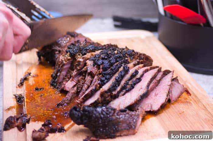 Sliced Fresh Grilled Tri Tip Steak on Wood Cutting Board Sliced Fresh Grilled Tri Tip Steak on Wood Cutting Board