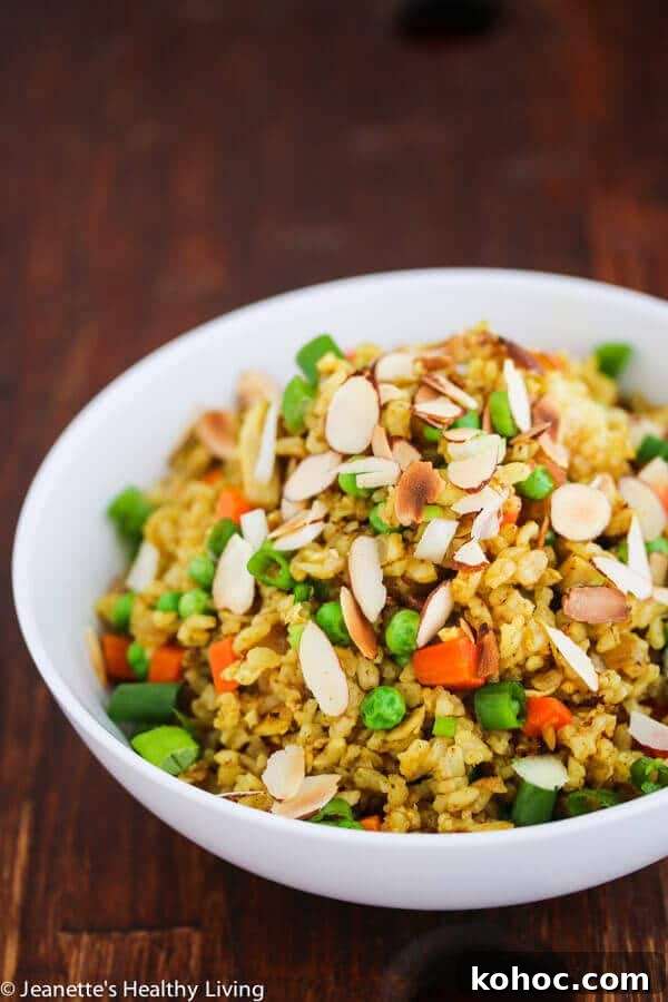 Chicken Curry Fried Rice: Flavorful Weeknight Recipe 2 Chicken Curry Fried Rice - a quick, easy and healthy one-pan dinner made with leftover cooked chicken, brown rice, carrots and peas. Toasted almonds make a nice crunchy topping.