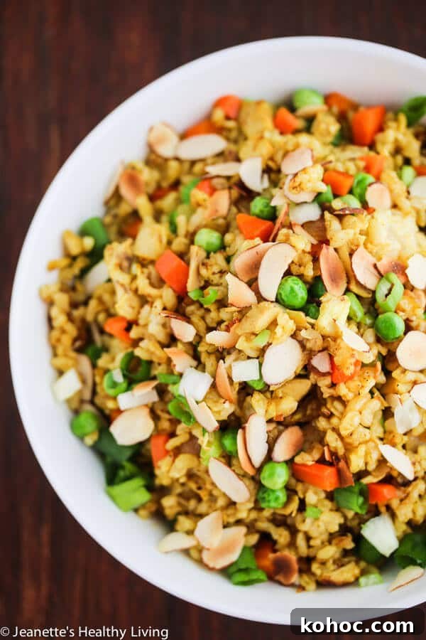 Chicken Curry Fried Rice: Flavorful Weeknight Recipe 4 Chicken Curry Fried Rice - a quick, easy and healthy one-pan dinner made with leftover cooked chicken, brown rice, carrots and peas. Toasted almonds make a nice crunchy topping.
