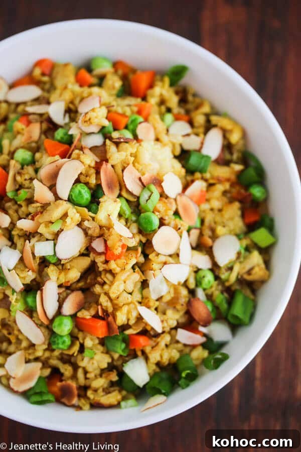 Chicken Curry Fried Rice: Flavorful Weeknight Recipe 5 Chicken Curry Fried Rice - a quick, easy and healthy one-pan dinner made with leftover cooked chicken, brown rice, carrots and peas. Toasted almonds make a nice crunchy topping.