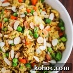 Chicken Curry Fried Rice: Flavorful Weeknight Recipe 7 Chicken Curry Fried Rice - a quick, easy and healthy one-pan dinner made with leftover cooked chicken, brown rice, carrots and peas. Toasted almonds make a nice crunchy topping.