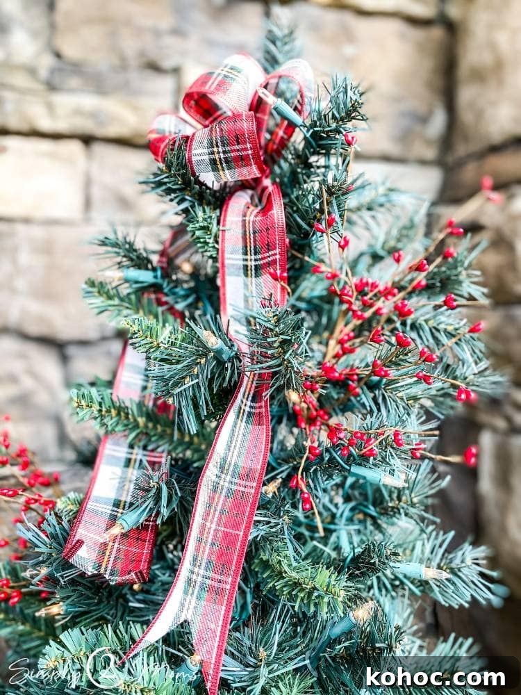 Create Fluffy Christmas Bows in 5 Simple Steps 16 plaid holiday bow on top of small Christmas tree on porch