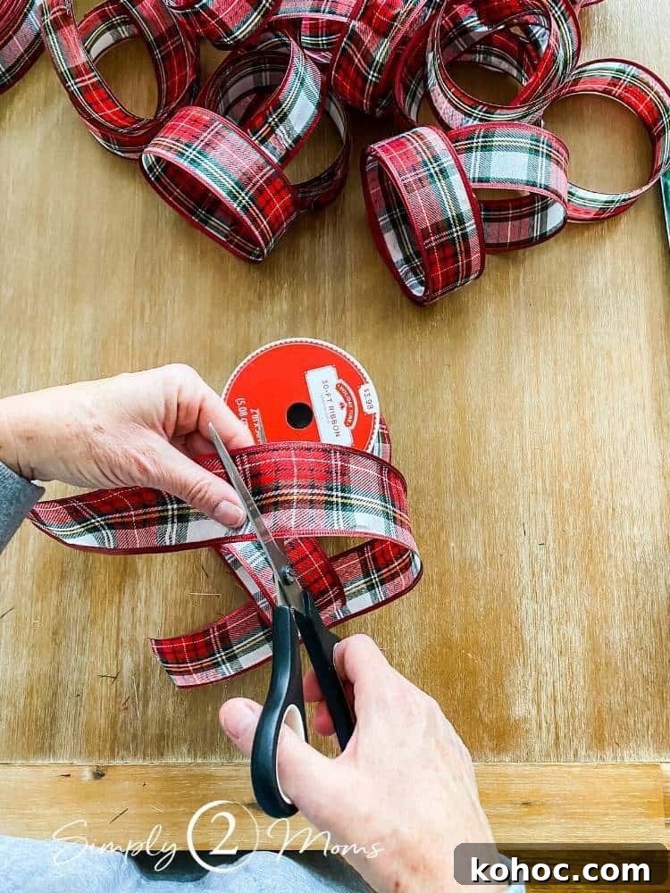 Create Fluffy Christmas Bows in 5 Simple Steps 4 two hands holding ribbon in one hand and scissors in other hand cutting ribbon